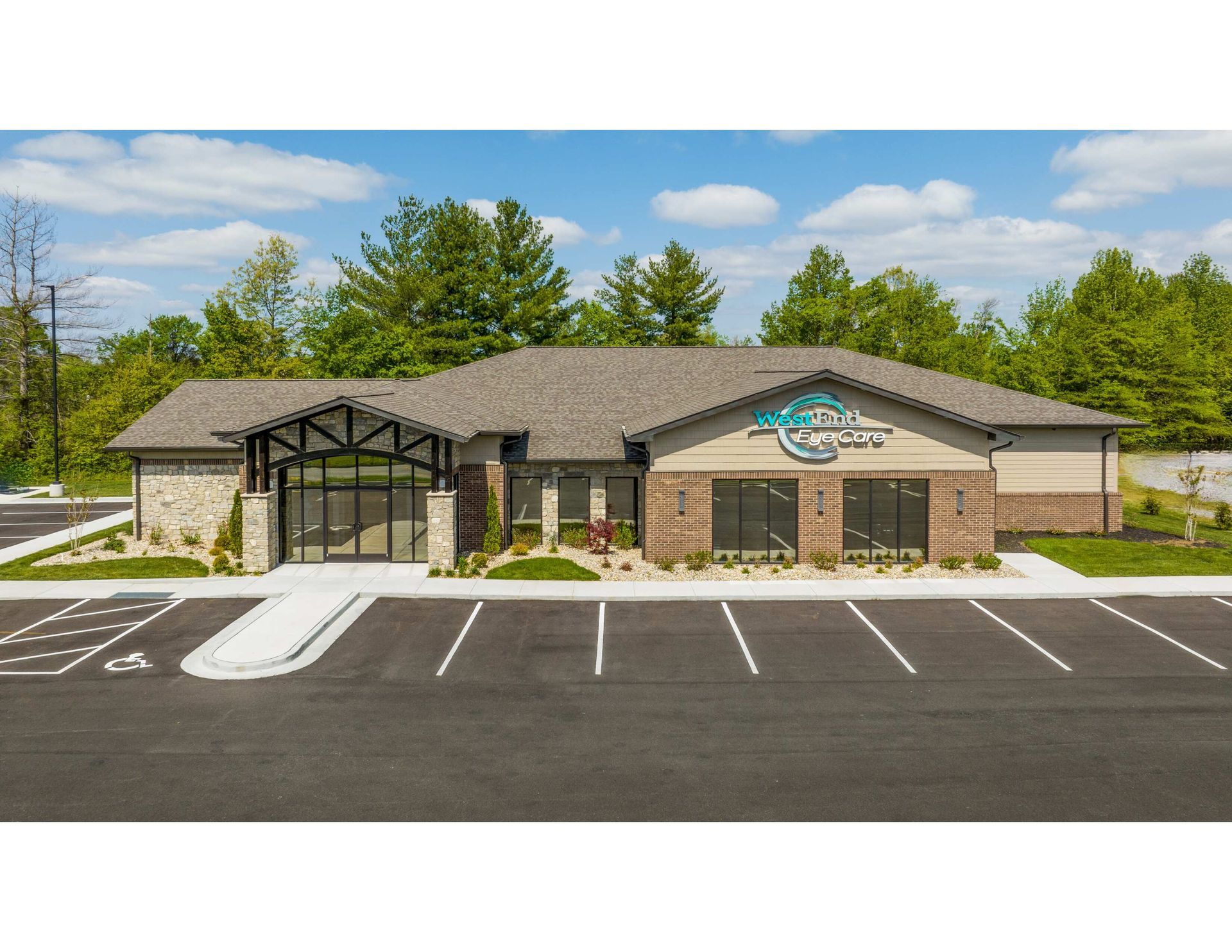 A large building with three american flags flying in front of it.