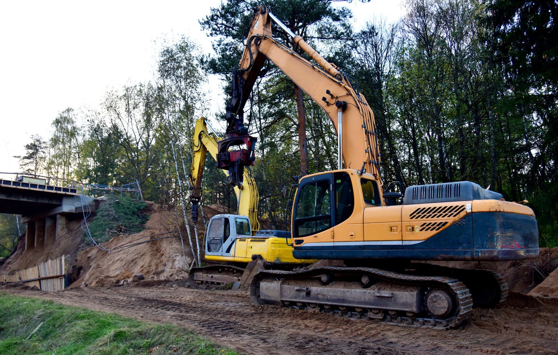 Excavator with drilling attachments — Peshtigo, WI — Carlson Forestry Mulching & Earthworks Excavator with drilling attachments — Peshtigo, WI — Carlson Forestry Mulching & Earthworks