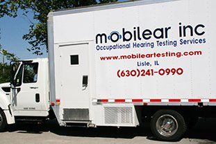 A mobilear inc truck is parked in a parking lot