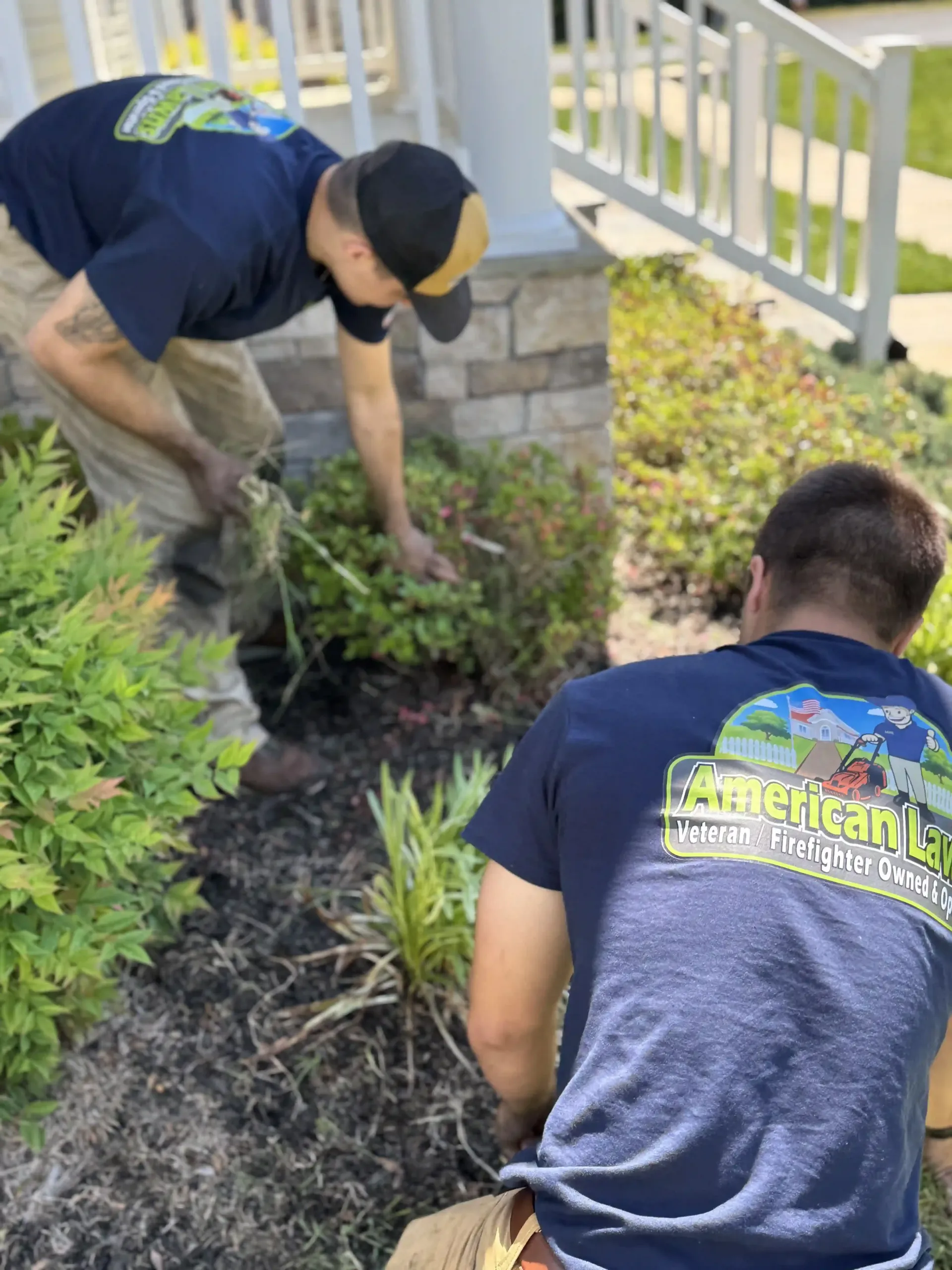 Two men are working in a garden in front of a house.