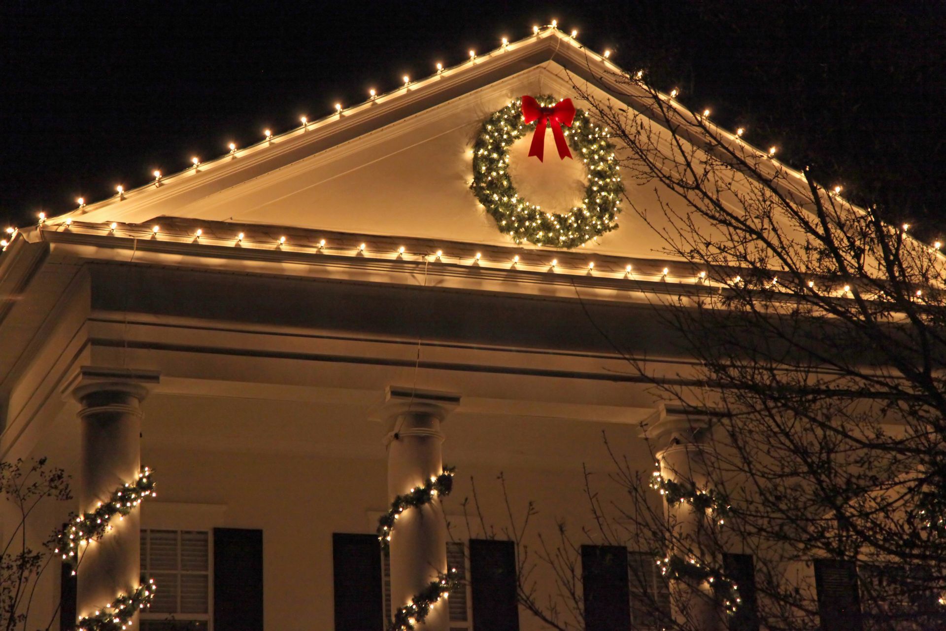 House decorated for Christmas with lights and a wreath.
