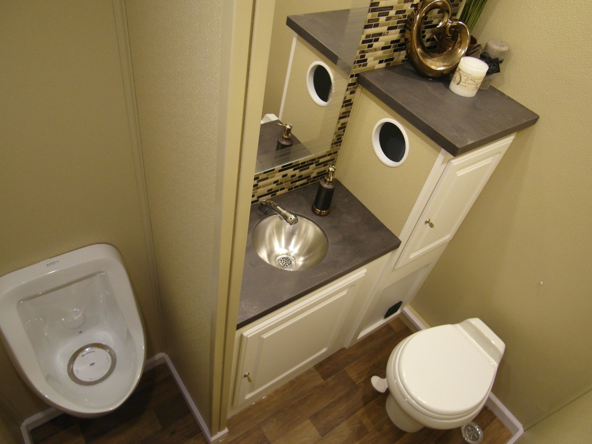 A bathroom with a toilet a sink and a mirror