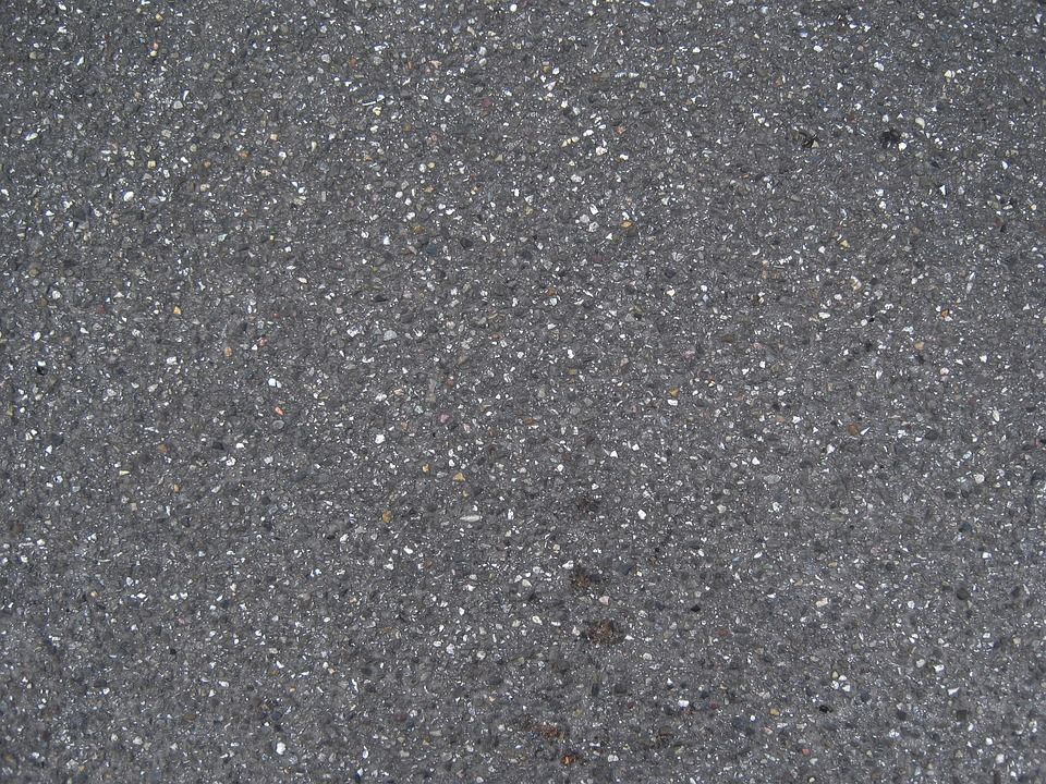 A close up of a gray surface with white dots on it.