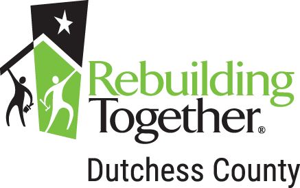 The logo for rebuilding together duchess county is green and black.