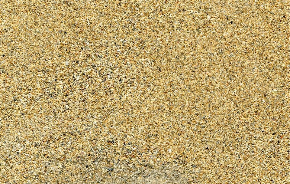 A close up of a pile of sand on a beach.