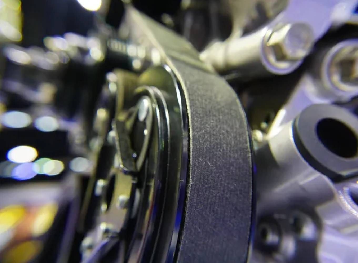 A man is holding a clutch disc in his hands.