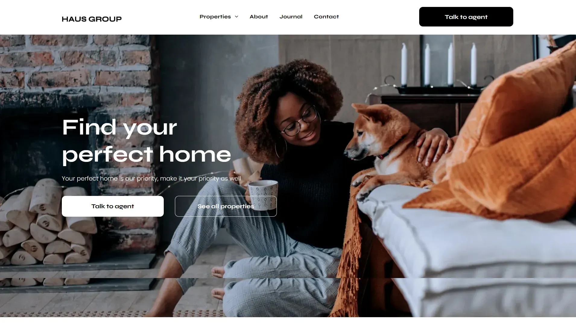 A woman is sitting on a couch with a dog.