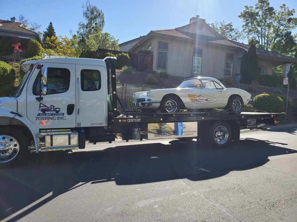 Truck Carrying a Luxury White Car — Concord, CA — ABC Towing