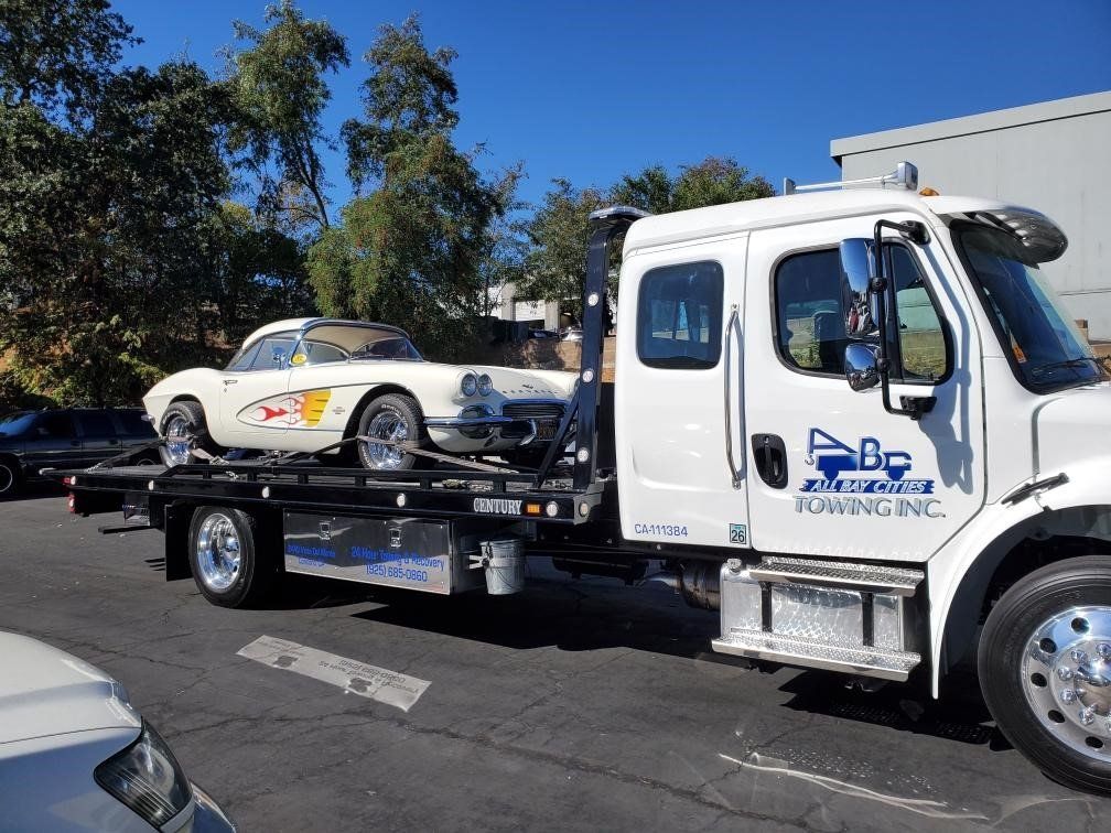 Truck Carrying a New White Car — Concord, CA — ABC Towing