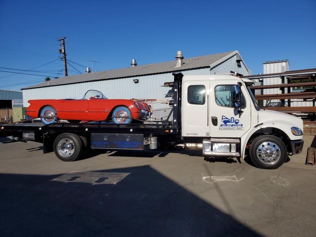 Truck Carrying a Red Car — Concord, CA — ABC Towing
