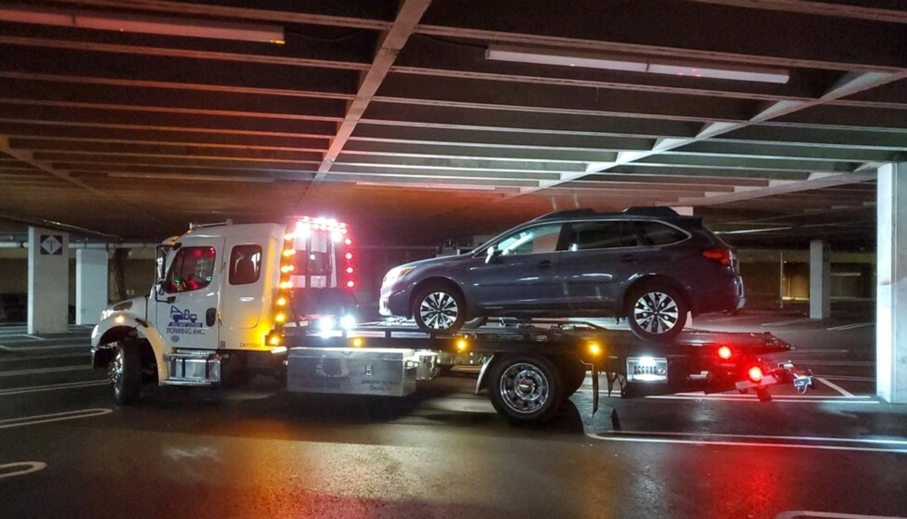 Truck Carrying a Car Inside the Parking Lot — Concord, CA — ABC Towing