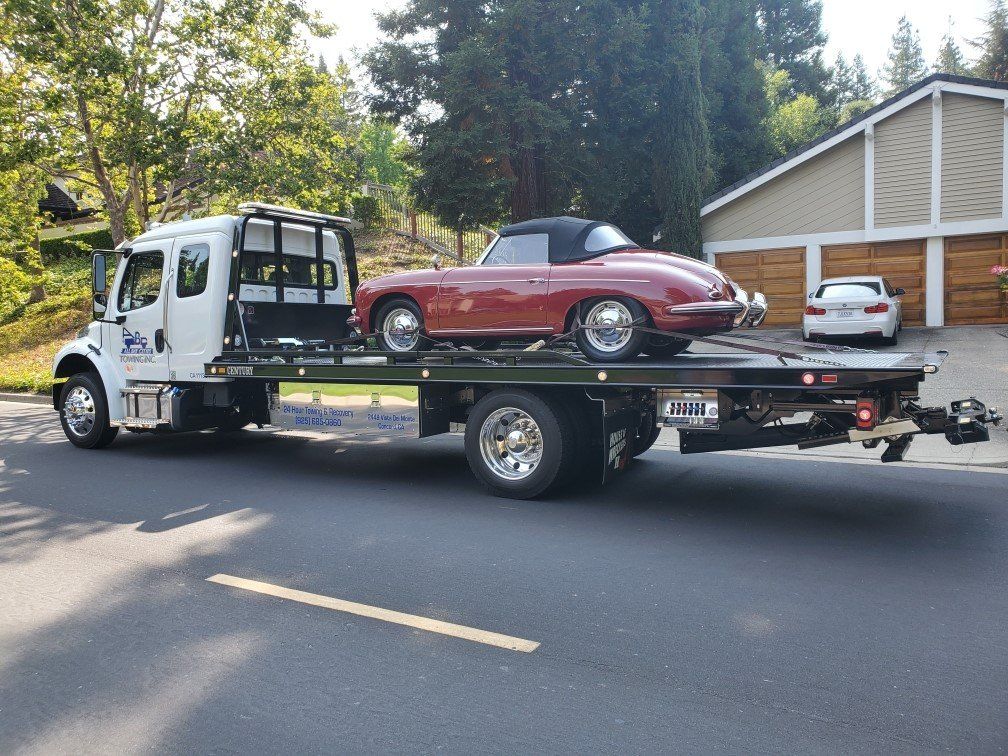 Truck Carrying a Red Luxury Car — Concord, CA — ABC Towing