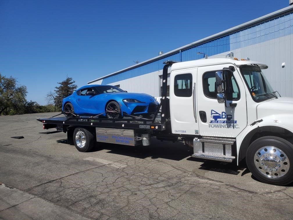 Truck Carrying a Blue Luxury Car — Concord, CA — ABC Towing