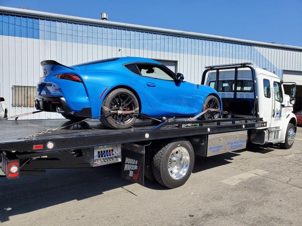 Truck Carrying a Blue Car — Concord, CA — ABC Towing