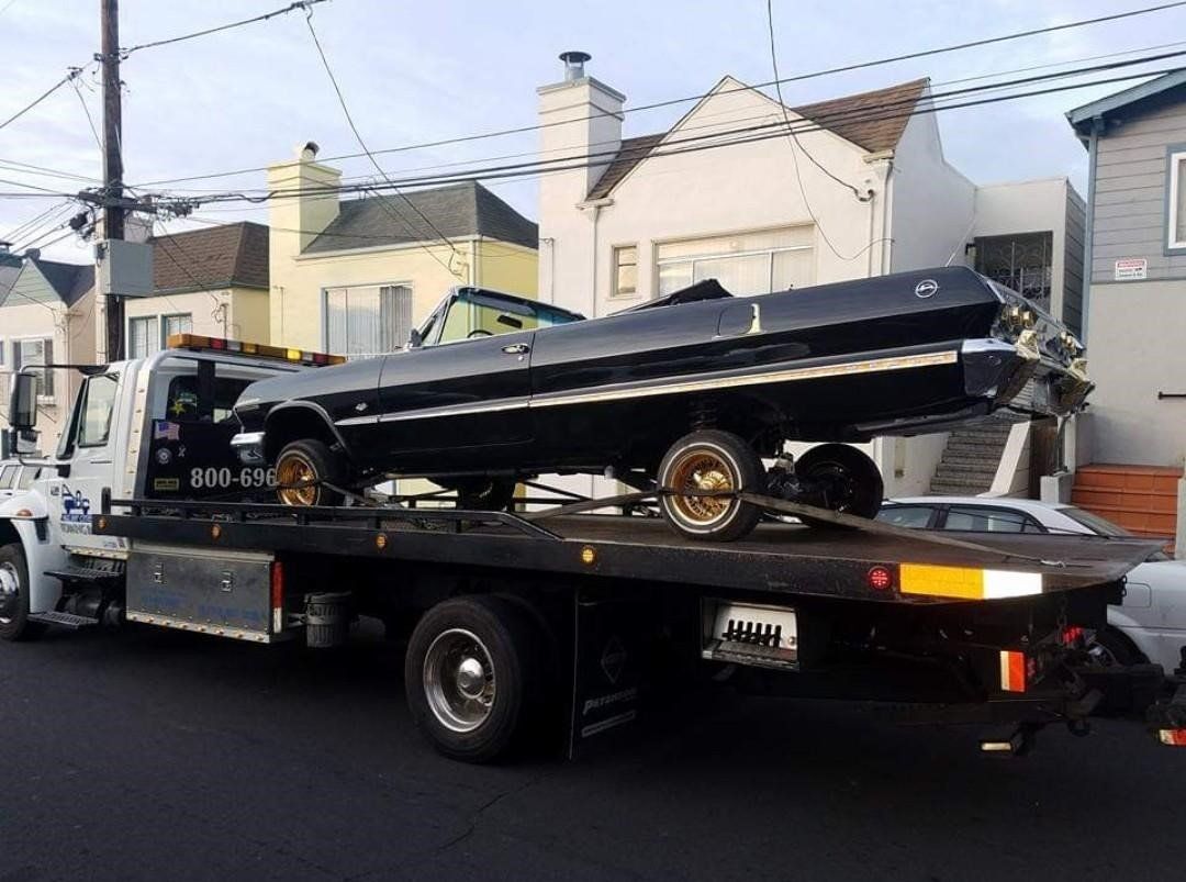 Truck Carrying a Black Luxury Car — Concord, CA — ABC Towing