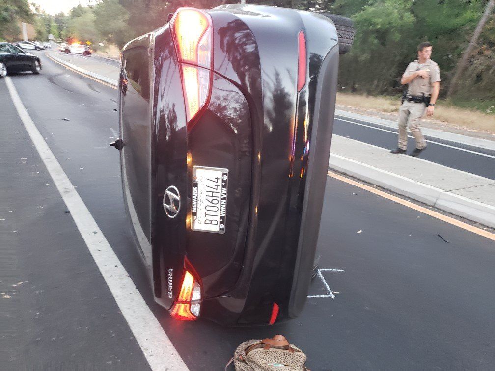 Black Car Flipped Due to an Accident — Concord, CA — ABC Towing