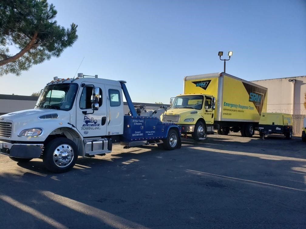 Tow Truck Pulling a Yellow Truck — Concord, CA — ABC Towing