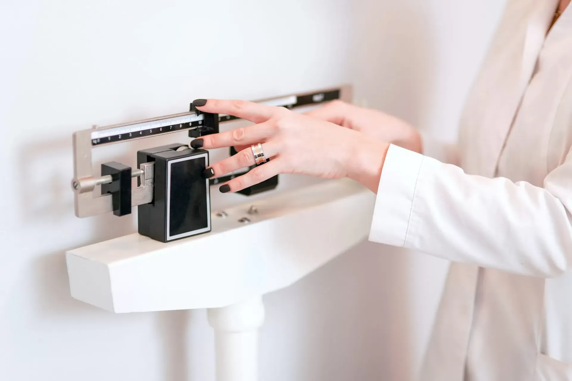 A woman is weighing herself on a scale.