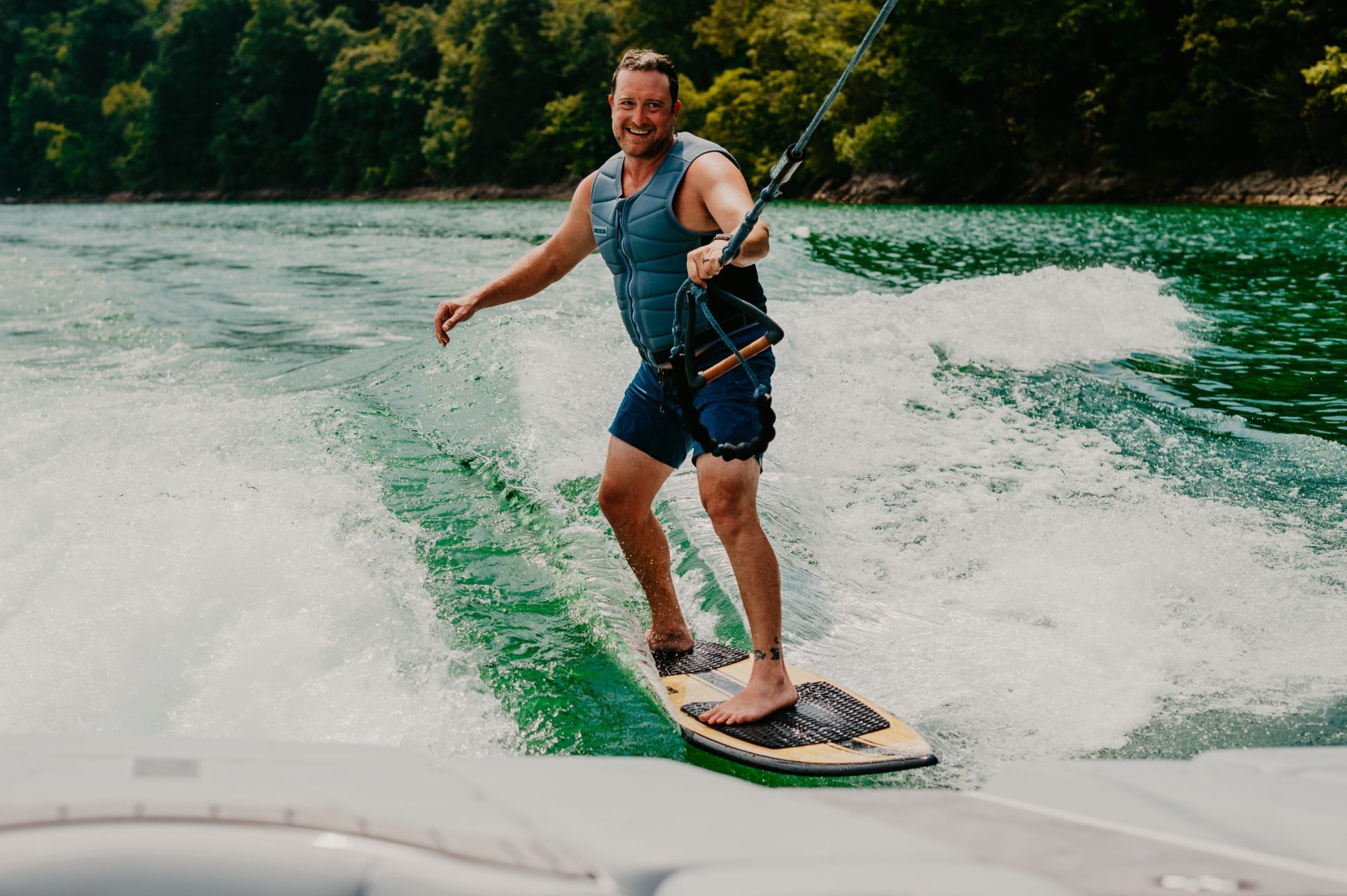 A man is riding a wave on a surfboard in the water