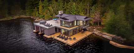 An aerial view of a house floating on top of a lake.