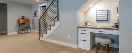 There is a desk under the stairs in the basement.