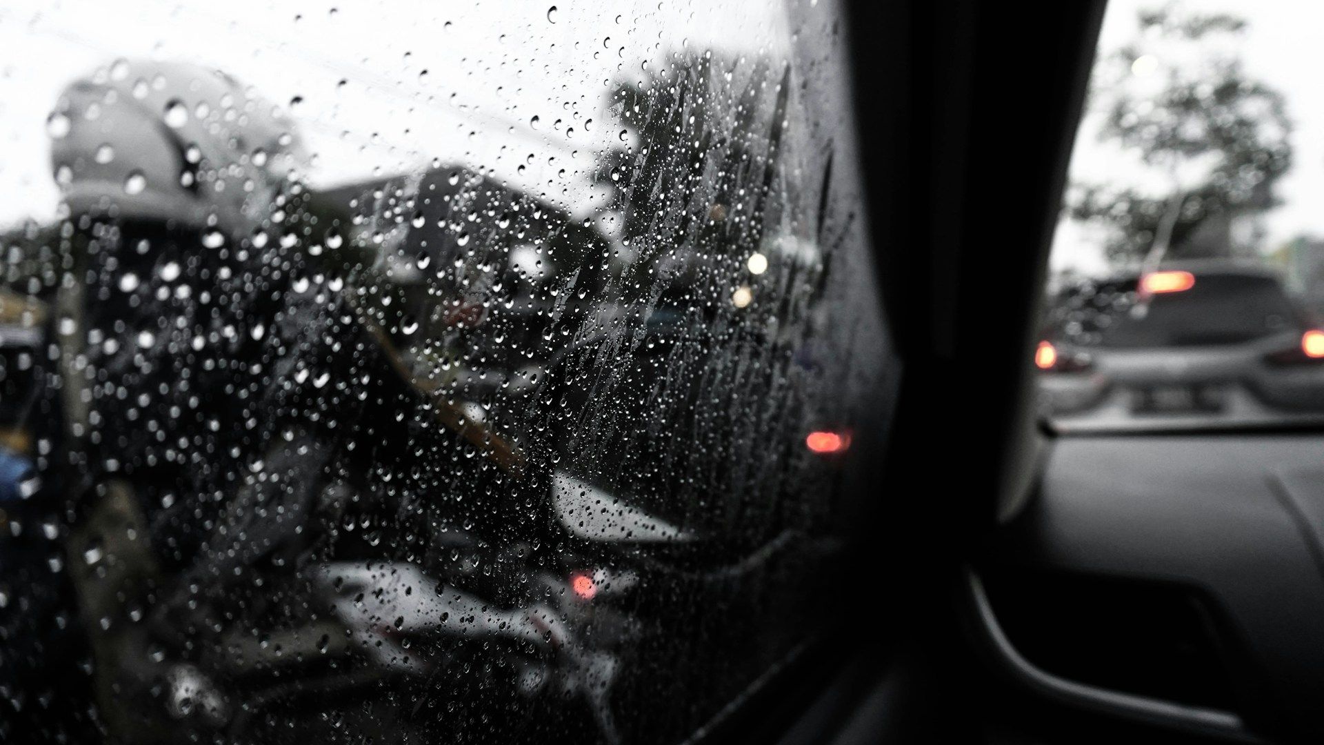 Water droplets on car window during rainstorm