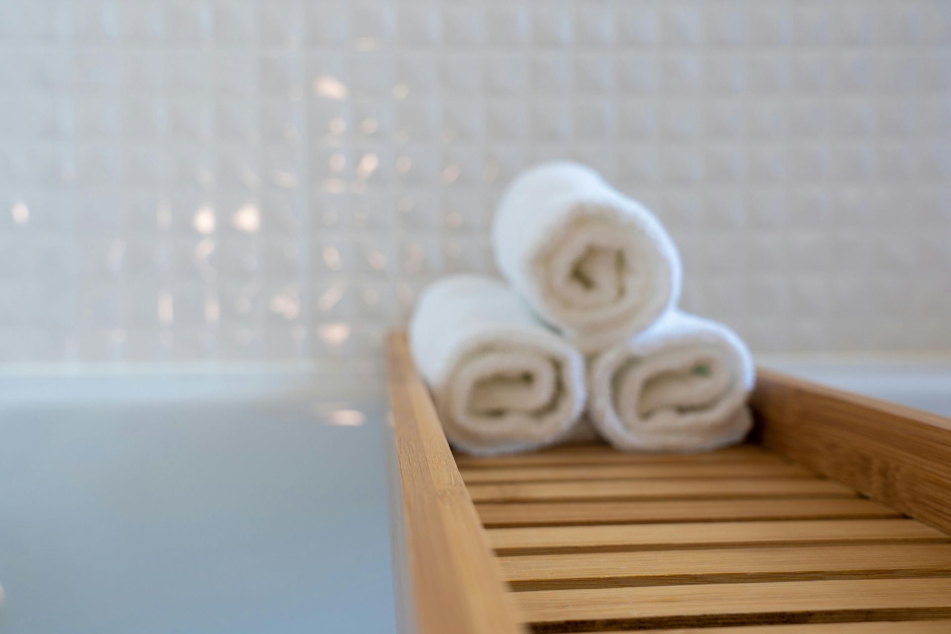 Bathroom storage organization with rolled towels for clean visuals
