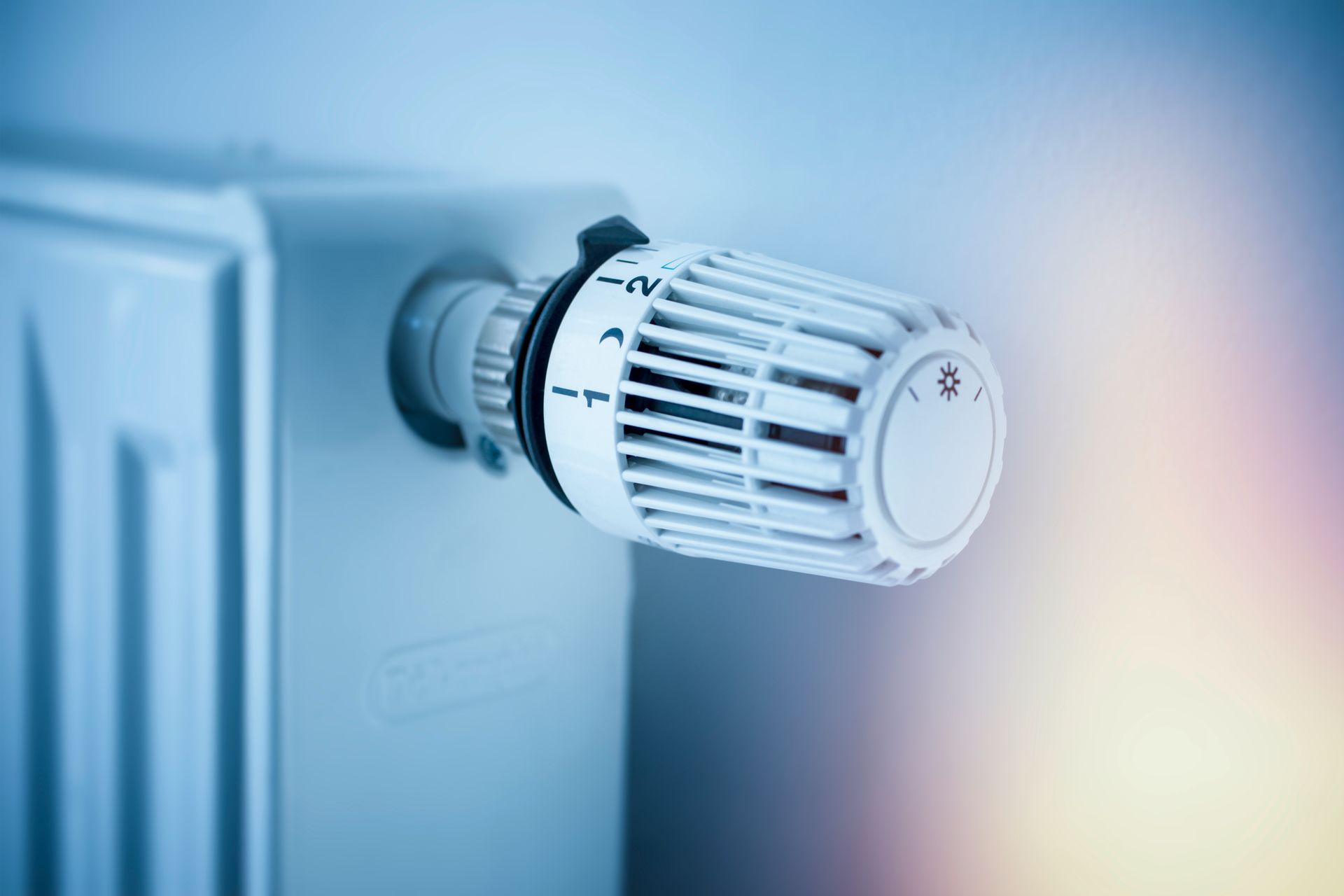 White panel radiator with a modern thermostat on the wall in an apartment White panel radiator with a modern thermostat on the wall in an apartment