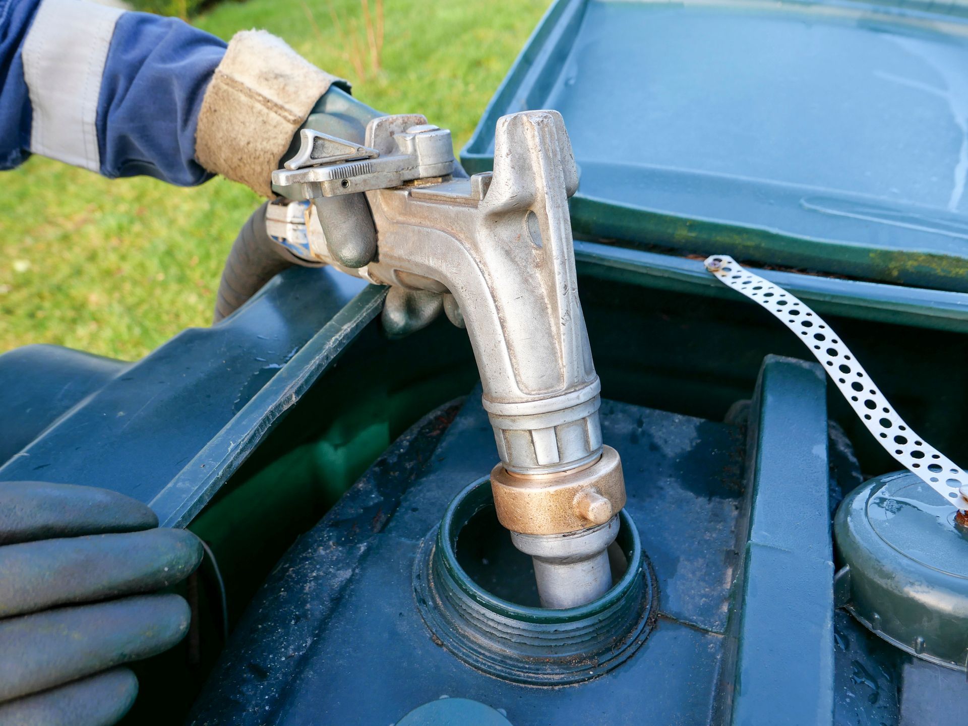 Heating oil delivery truck refills rural home tank in winter for reliable residential heating.