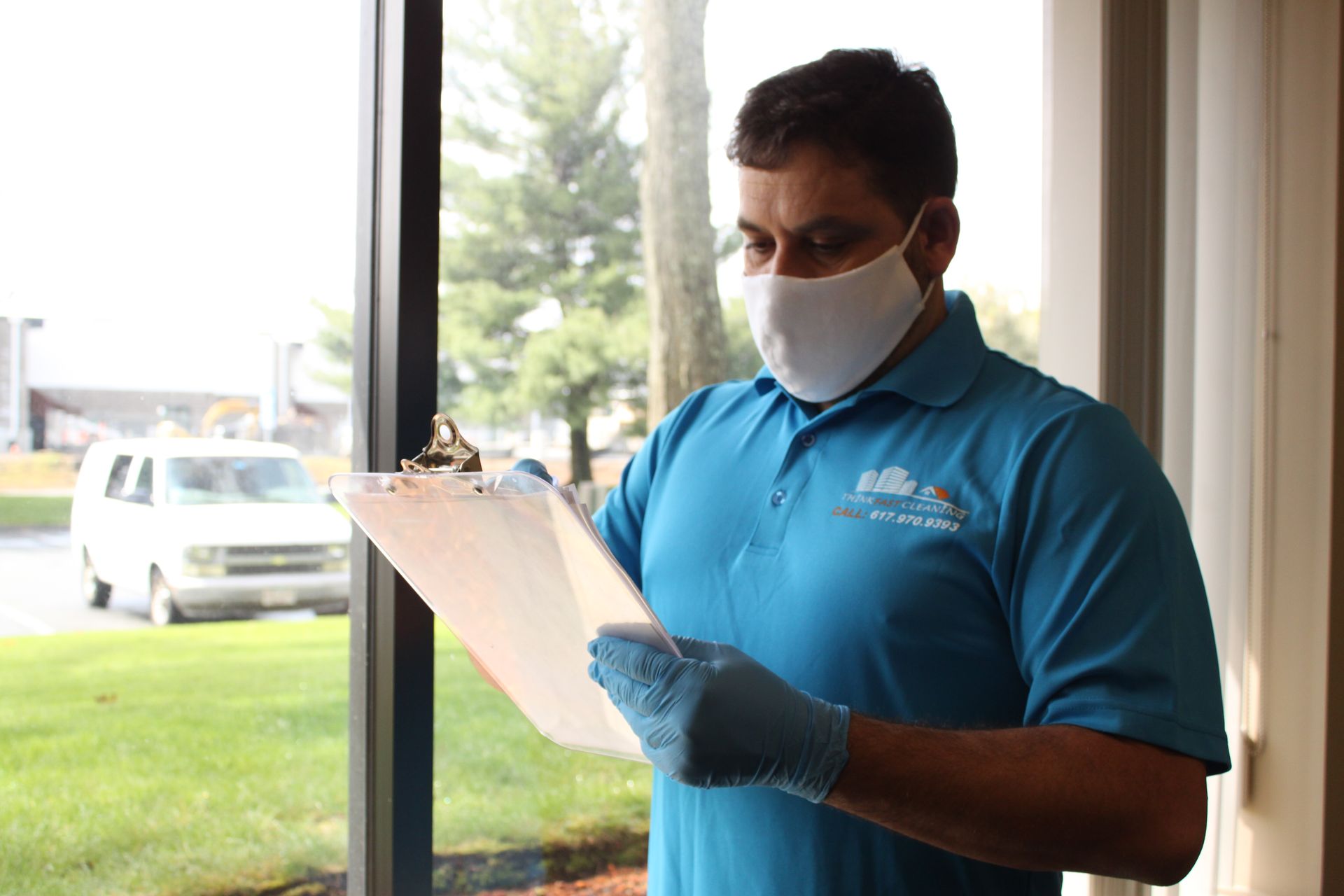 Office cleaning employee reviewing the cleaning checklist after a completed job in Somerville MA.