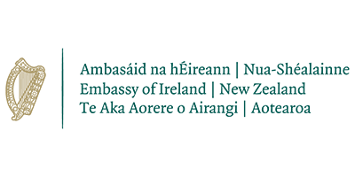 Logo for the Embassy of Ireland in New Zealand, featuring the Irish harp and text in Irish, English, and Te Reo Māori.