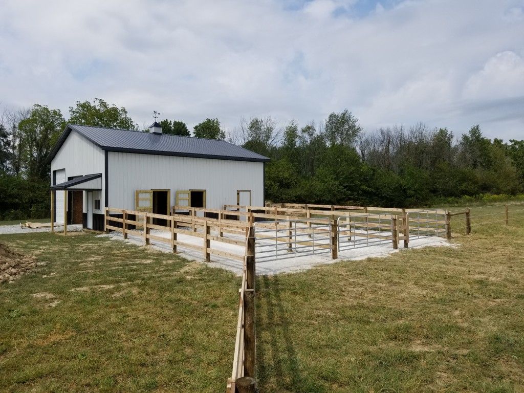 A Rustic Barn With A Wooden Fence And A Horse Stall - Columbus, IN - Indiana Agricultural Fencing