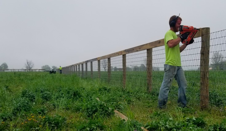 Man Fixing A Fence - Columbus, IN - Indiana Agricultural Fencing