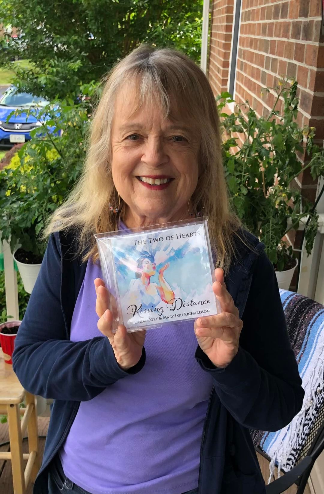 A woman is holding a piece of paper in her hands and smiling.