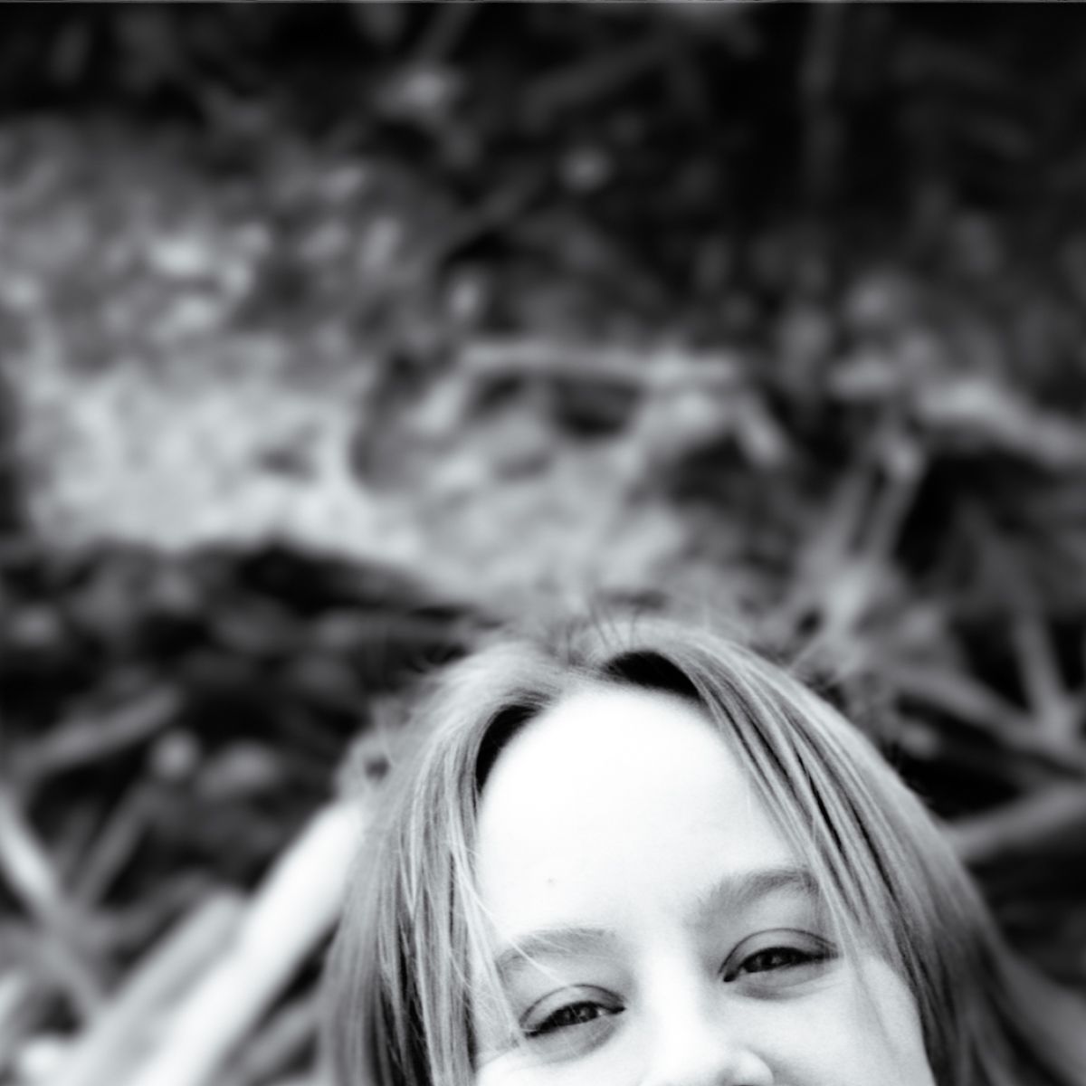 A woman is smiling in a black and white photo