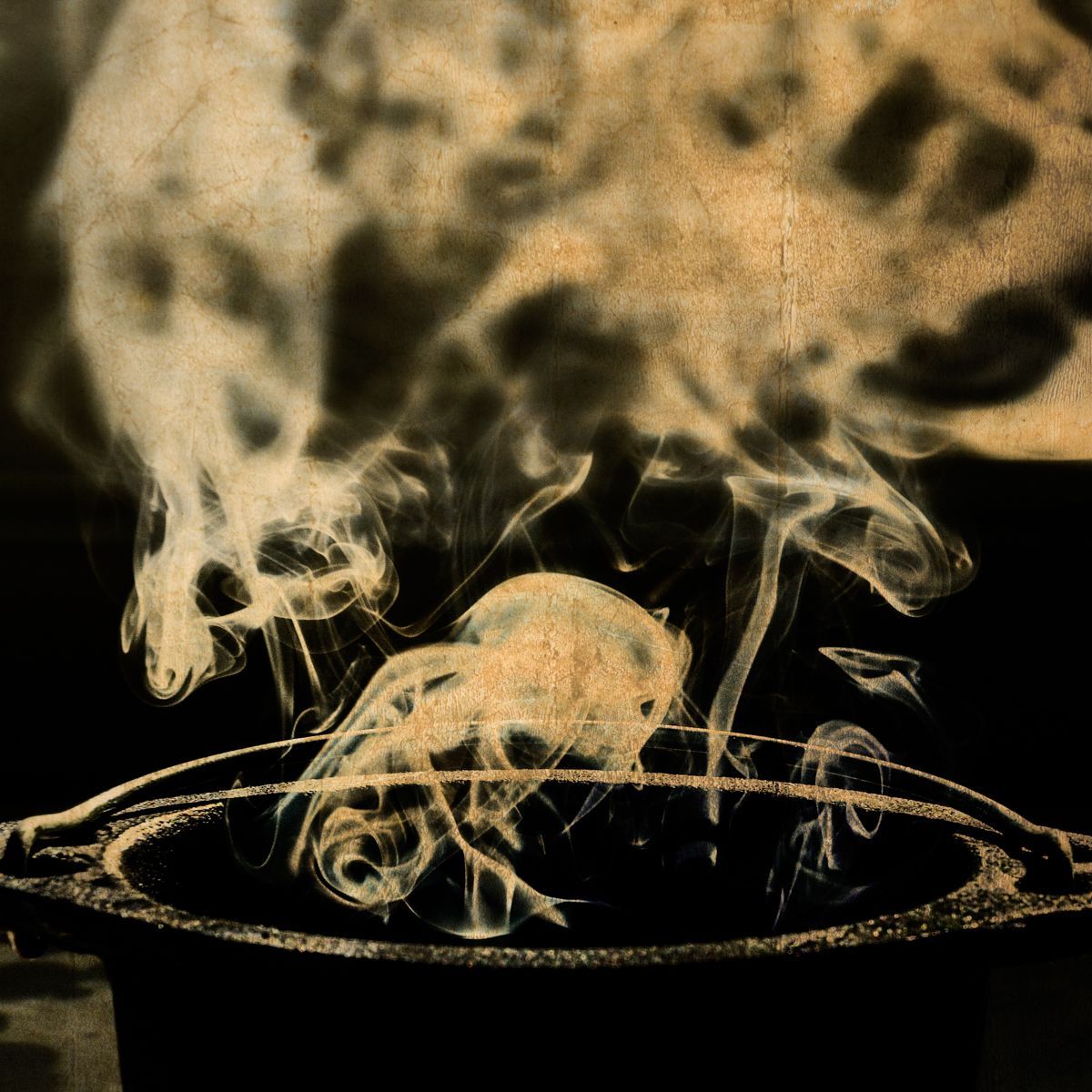 A black and white photo of smoke coming out of a pot