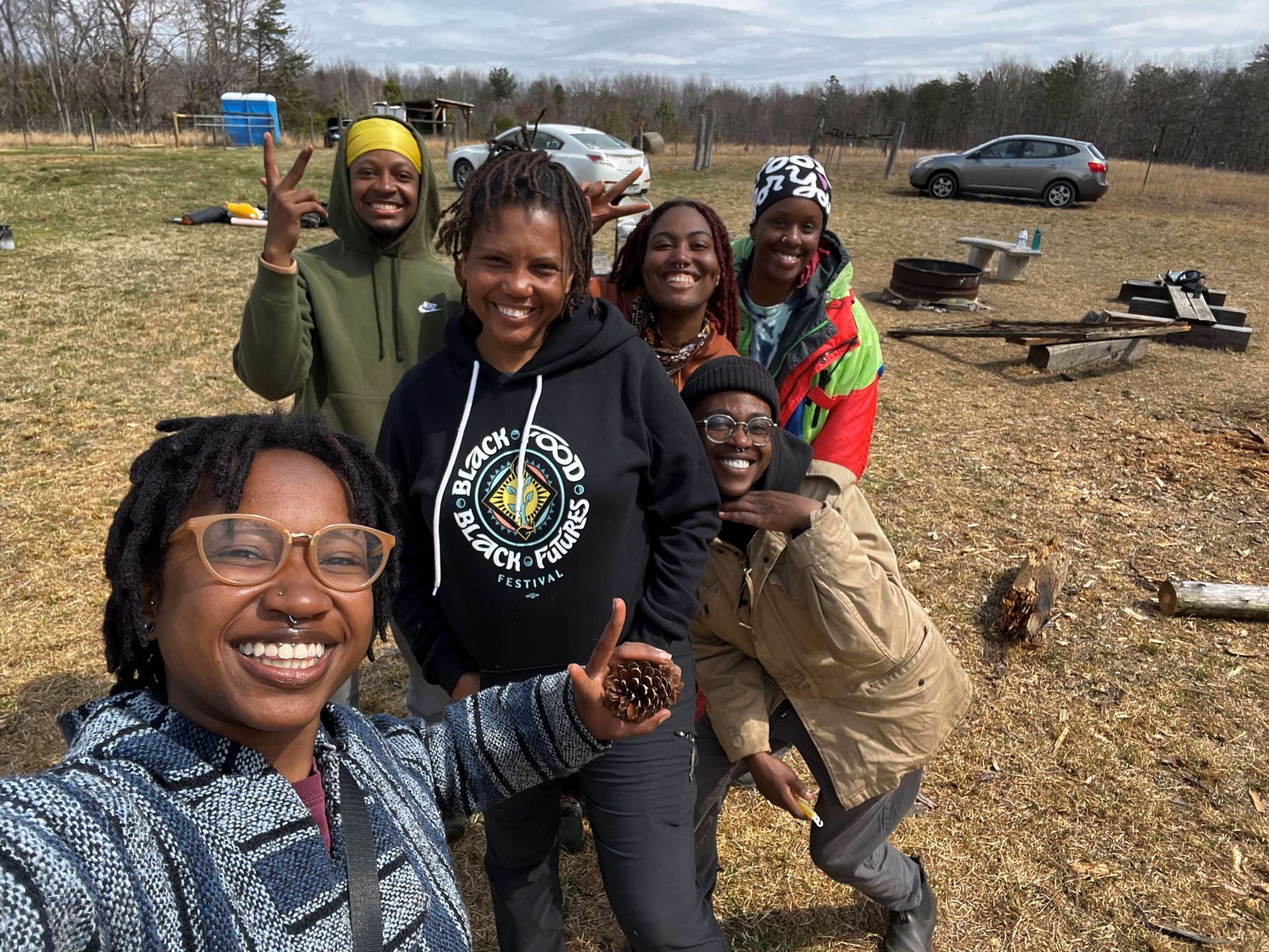 A group of people are posing for a picture in a field.