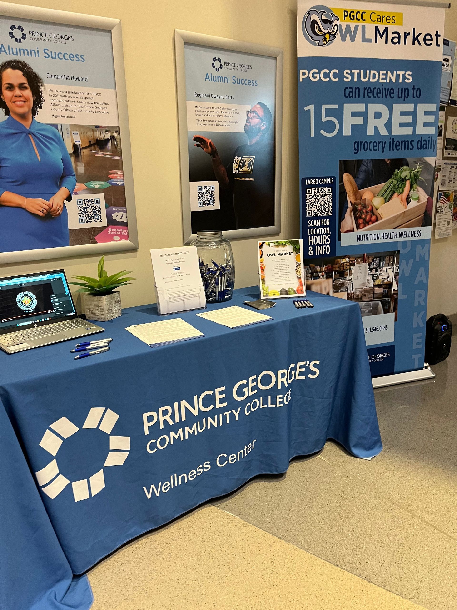 A table with a blue table cloth that says prince george 's community college