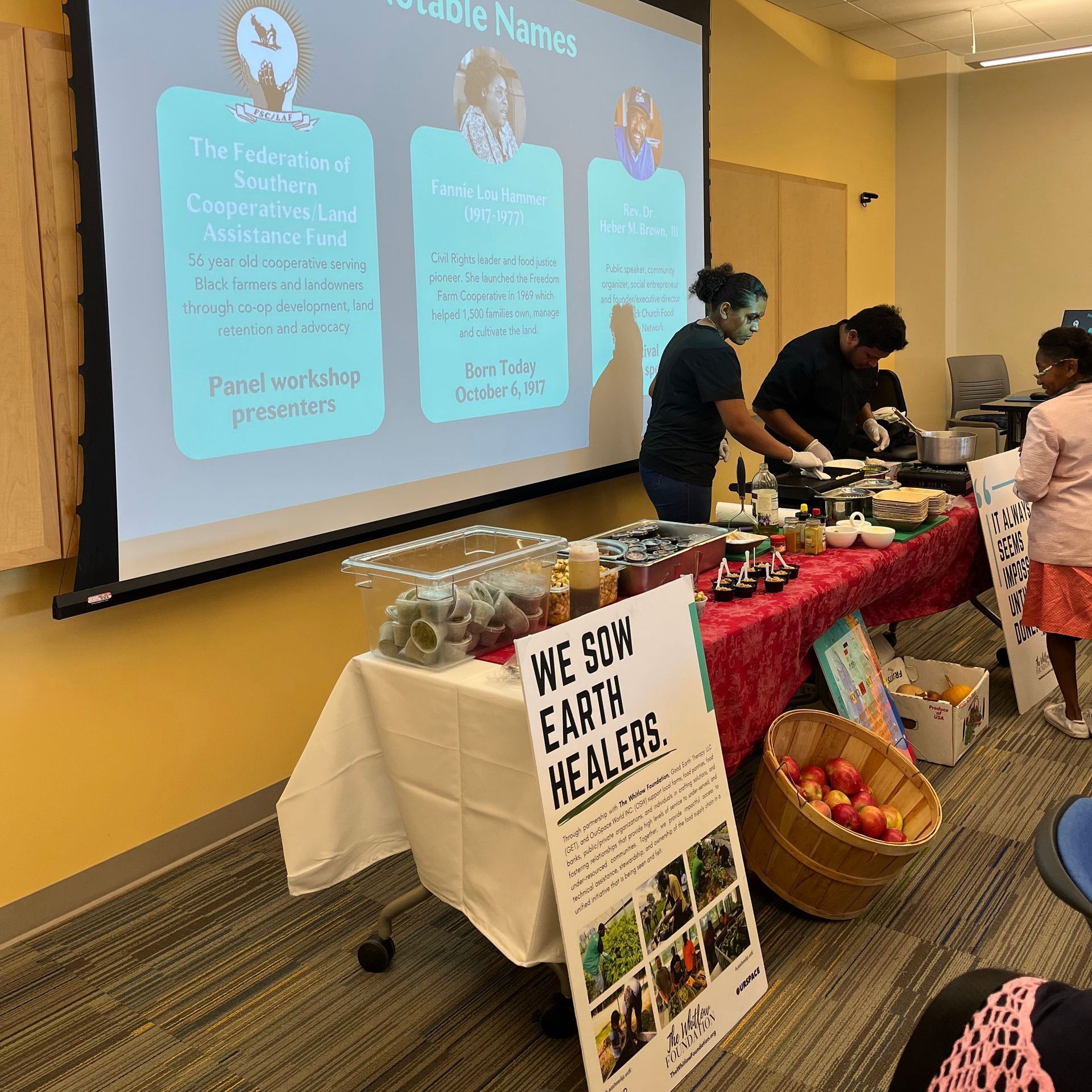 A group of people standing around a table with a sign that says we son earth healers