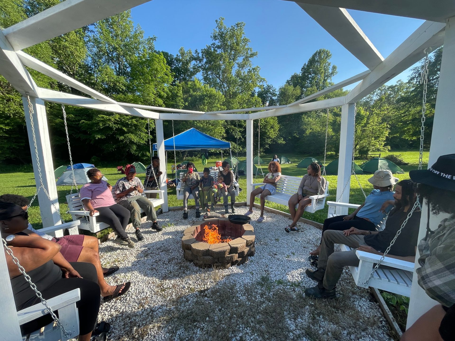 A group of people are sitting around a fire pit.