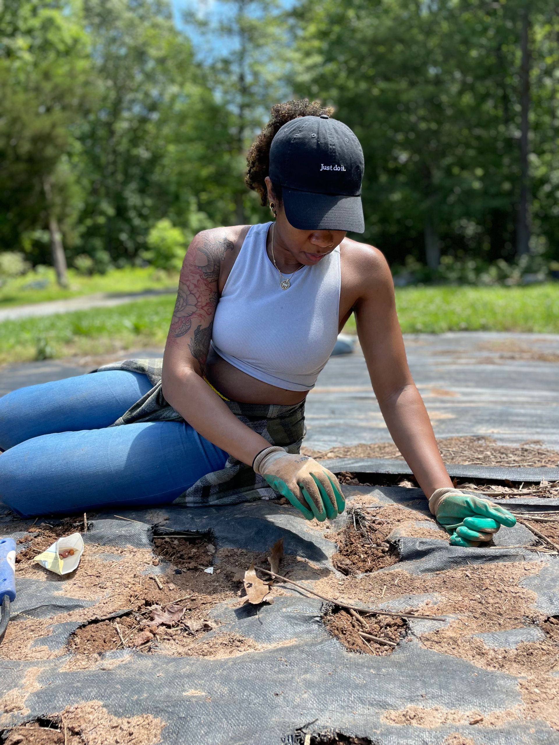 A man is sitting in a boat filled with vegetables.