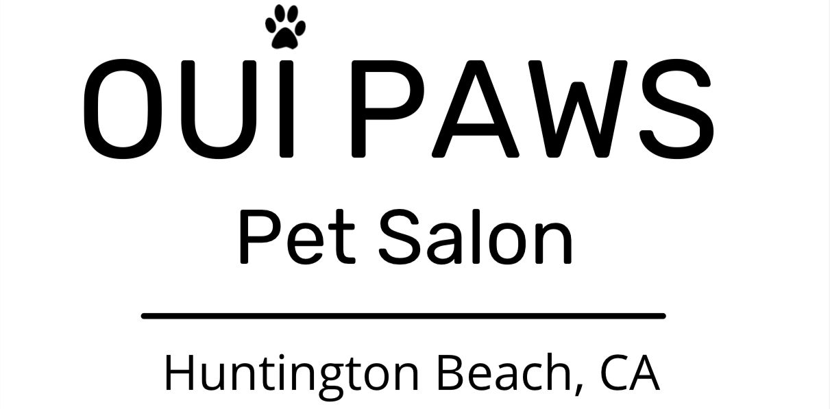 Logo for "Oui Paws" pet salon in Huntington Beach, CA, with a paw print icon above the words "Oui Paws."