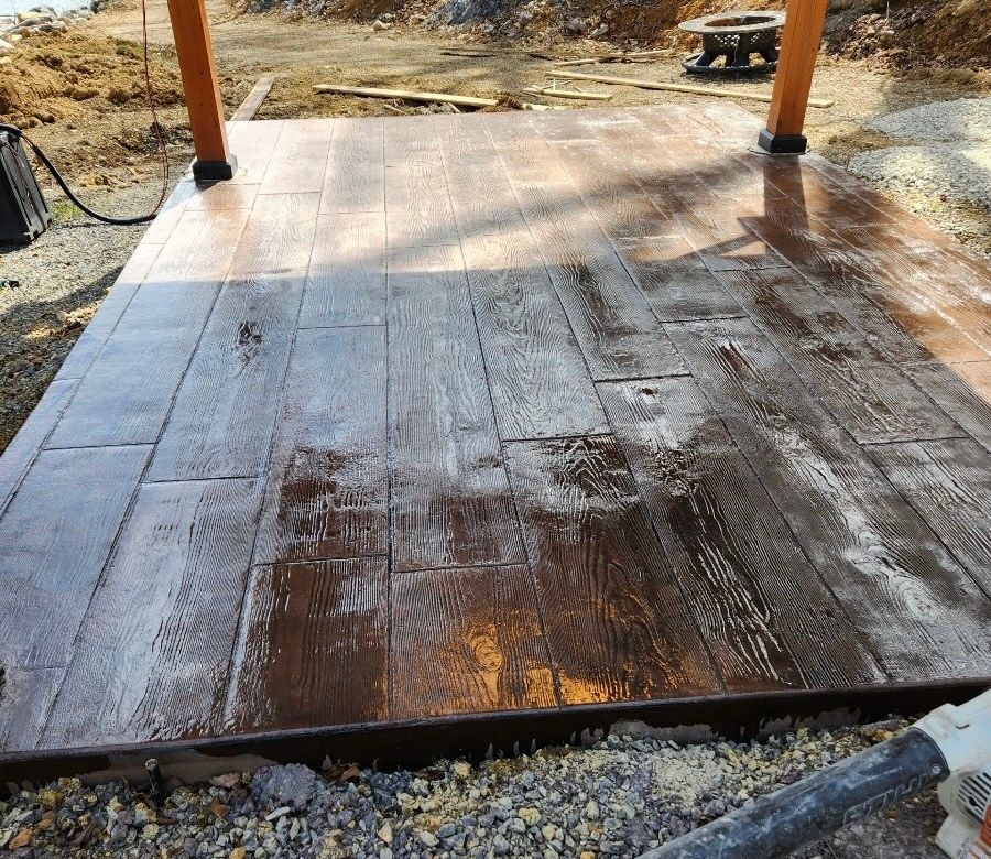 Weathered wooden porch deck with two posts and sunlight casting shadows over the planks.