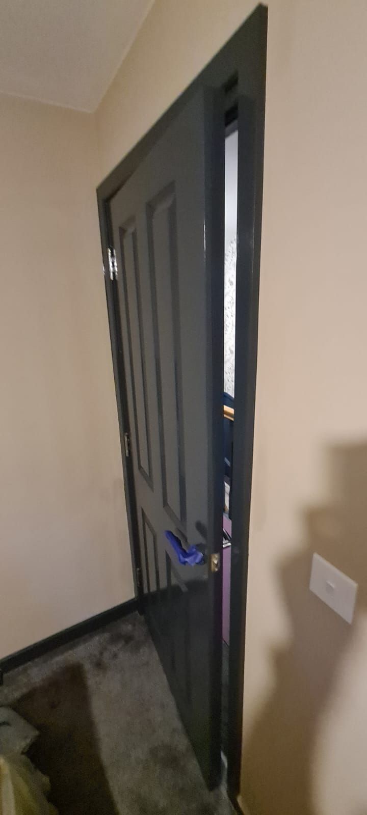 A picture of an internal door glossed in dark grey by painters and decorators southampton