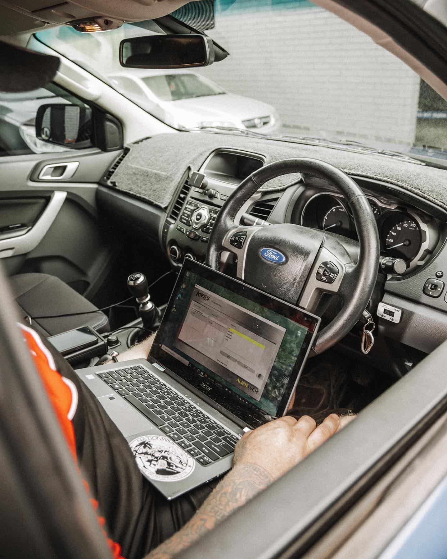 A Person is Sitting in a Car Using a Laptop Computer — Nationwide Auto Service Centre in West Gosford, NSW