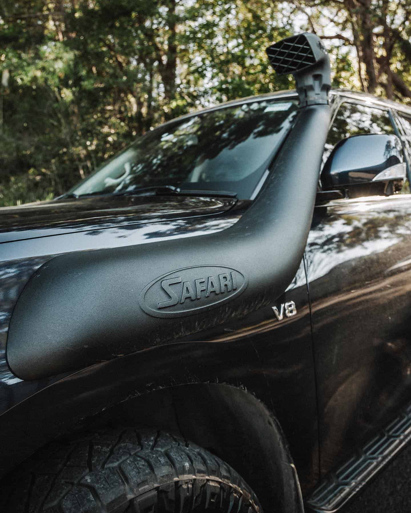 A Black SUV With a Snorkel on the Hood is Parked in the Woods — Nationwide Auto Service Centre in West Gosford, NSW