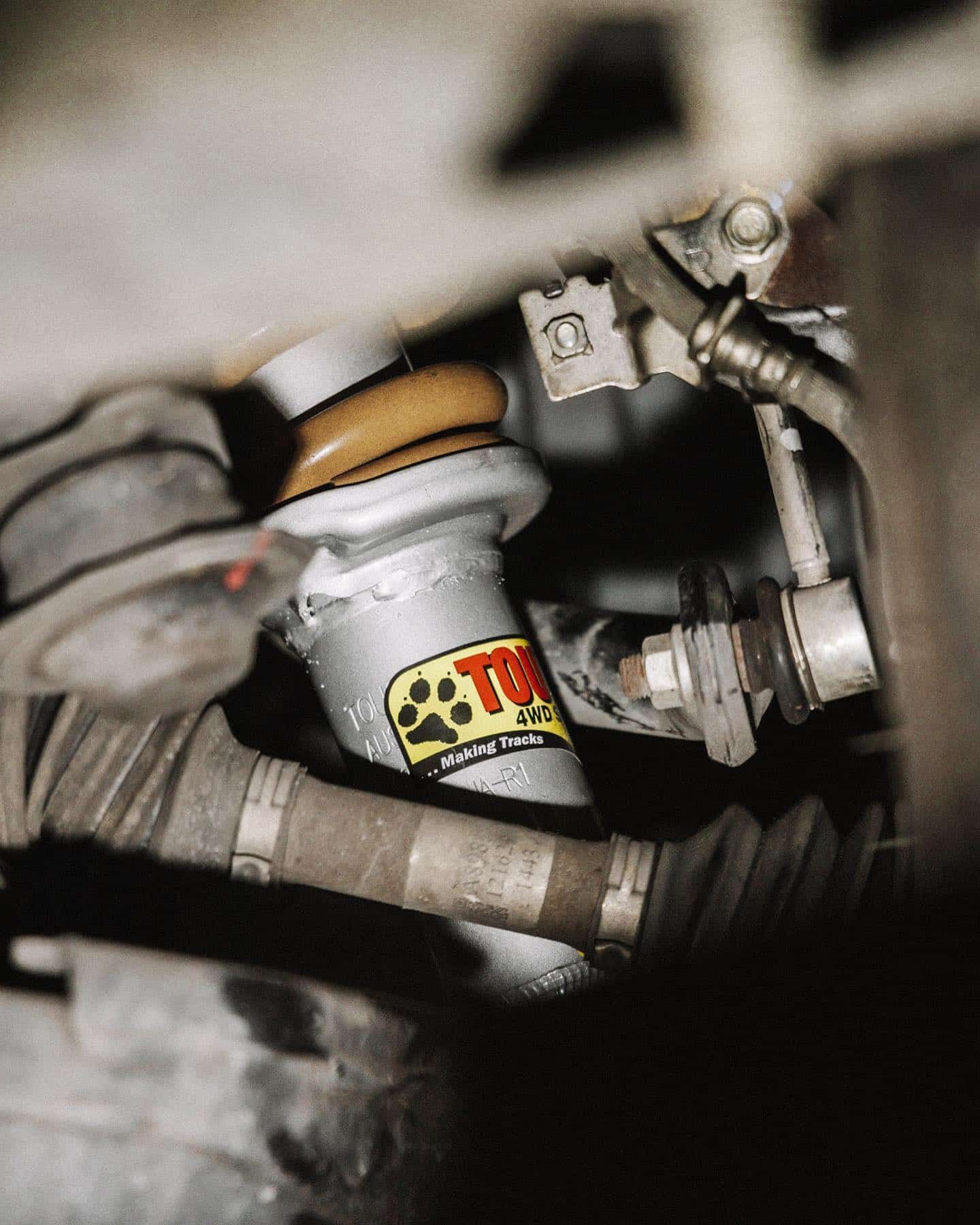 A Close Up of a Shock Absorber With a Paw Print on It — Nationwide Auto Service Centre in West Gosford, NSW