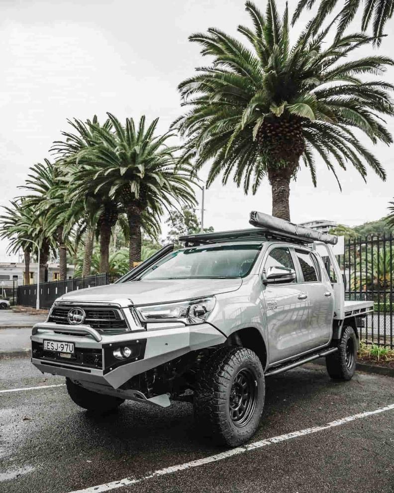 A Silver Truck is Parked in a Parking Lot Next to Palm Trees — Nationwide Auto Service Centre in West Gosford, NSW