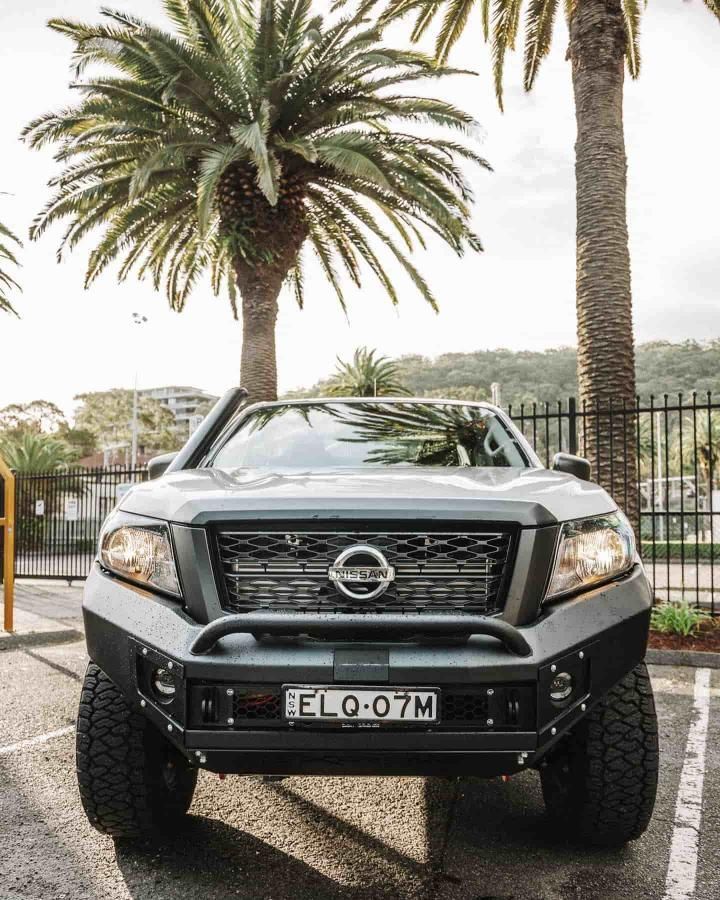 A Nissan Truck is Parked in a Parking Lot Next to Palm Trees — Nationwide Auto Service Centre in West Gosford, NSW