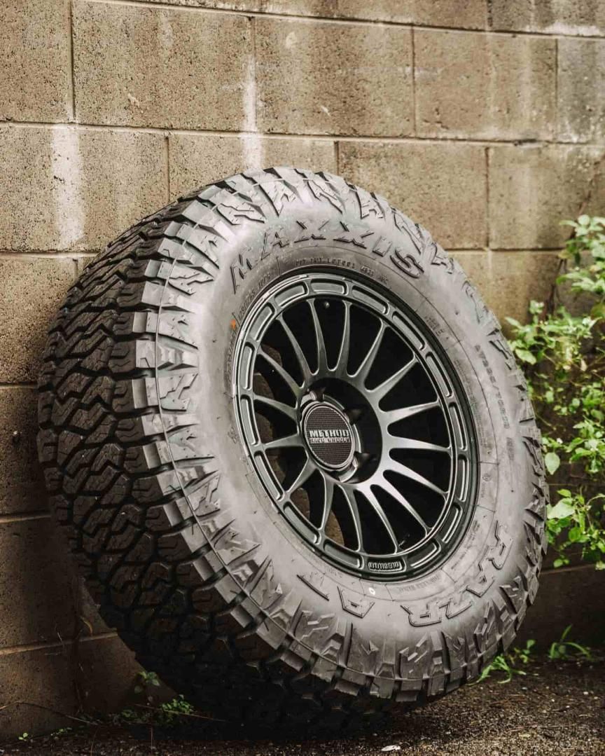A Large Tire is Leaning Against a Brick Wall — Nationwide Auto Service Centre in West Gosford, NSW